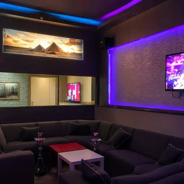 Interior of Shisha Lounge Angelo with pyramids wall art and lounge seating