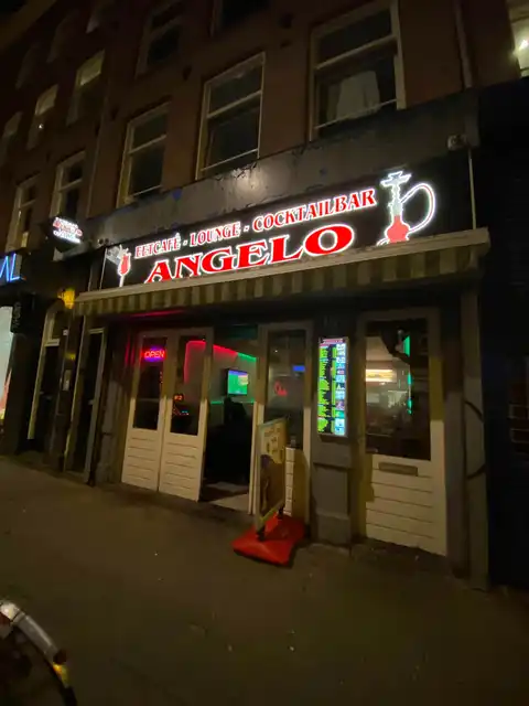 Shisha Lounge Angelo storefront on Albert Cuypstraat at night
