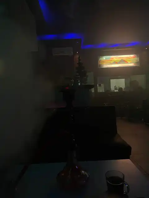 Shisha session with pyramids wall art at Angelo Lounge